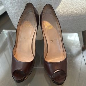 Christian Louboutin platform pumps in brown.